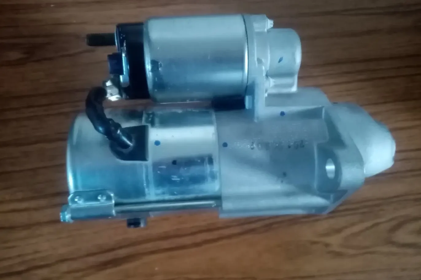 Car Starter Problems: The Ultimate Diagnostic & Repair Guide 4 Brand new car starter motor on workbench showing replacement parts for fixing common car starter problems - professional electromechanic repair