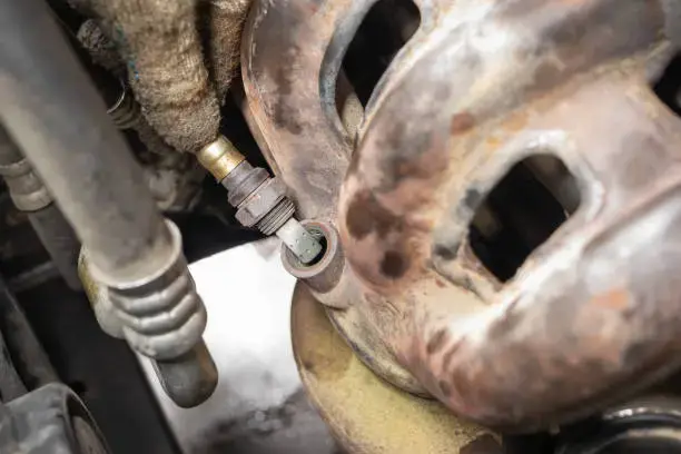 Damaged O2 sensor showing visible symptoms of a bad oxygen sensor on a vehicle.