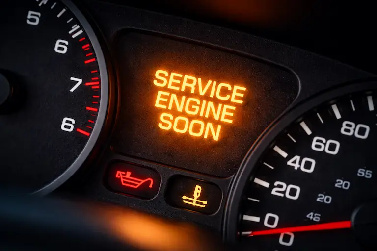 Service Engine Soon – Here's What a Mechanic With 18 Years on the Job Wants You to Know 7 Service Engine Soon warning light illuminated on a car dashboard, indicating a maintenance or early engine issue