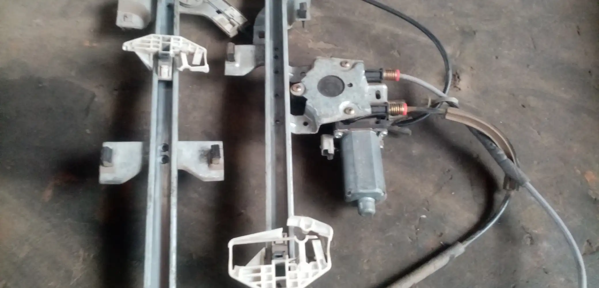 Car Window Motor Repair: Expert Tips, Costs & DIY Advice 2 car Window motor with sensor on a mechanic’s workbench