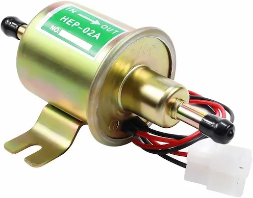 Electric Fuel Pump for a Carburetor: Signs, Fixes, and Expert Tips 2 Close-up view of an electric fuel pump for a carburetor showing its wiring and fuel line connections in a car workshop.